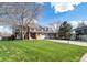 Two-story home with large front yard, mature trees, and a three-car garage at 20838 Parliament Ct, Parker, CO 80138
