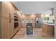 Bright kitchen featuring custom wood cabinets, stainless steel appliances, and a mobile kitchen island at 20838 Parliament Ct, Parker, CO 80138