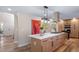 Open-concept living space with kitchen island featuring bar seating and views of the front entrance at 20838 Parliament Ct, Parker, CO 80138