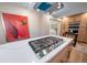 Bright, modern kitchen featuring a cooktop island, stainless steel appliances, and custom wooden cabinets at 20838 Parliament Ct, Parker, CO 80138