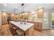 Spacious kitchen featuring an island with breakfast bar, custom lighting, and views to the back yard at 20838 Parliament Ct, Parker, CO 80138