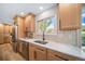 Well-lit kitchen area featuring wood cabinets, stainless steel appliances and a sink with backyard views at 20838 Parliament Ct, Parker, CO 80138