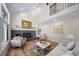 Bright living room featuring a brick fireplace, large window, high ceilings, and stylish furniture at 20838 Parliament Ct, Parker, CO 80138