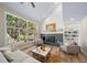 Bright living room featuring a brick fireplace, large window and stylish furniture perfect for relaxation at 20838 Parliament Ct, Parker, CO 80138