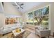 Sun-drenched living room with vaulted ceilings, a cozy seating arrangement, and beautiful backyard views at 20838 Parliament Ct, Parker, CO 80138