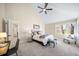 Comfortable main bedroom featuring a ceiling fan, vaulted ceiling and ample natural light at 20838 Parliament Ct, Parker, CO 80138