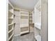 Spacious walk-in closet with white shelving and closet rods at 20838 Parliament Ct, Parker, CO 80138