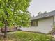 Exterior view of home with a small wood deck and verdant lawn at 19346 E Clear Creek Way, Parker, CO 80134
