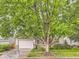Charming home featuring a well-manicured lawn, mature trees, and a welcoming two-car garage at 19346 E Clear Creek Way, Parker, CO 80134