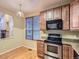 Well-lit kitchen area featuring stainless appliances, stone countertops, and ample cabinet space at 19346 E Clear Creek Way, Parker, CO 80134