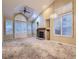 Bright living room featuring vaulted ceilings, a fireplace, and large windows with plantation shutters at 19346 E Clear Creek Way, Parker, CO 80134