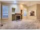 Large living room featuring a fireplace, windows with shutters, and connection to the kitchen at 19346 E Clear Creek Way, Parker, CO 80134