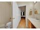 Bright bathroom featuring a modern sink, wood cabinet, and neutral tones at 12943 Lafayette St # F, Thornton, CO 80241