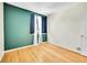 Bright bedroom with sleek wood floors, neutral walls, and a window providing natural light at 12943 Lafayette St # F, Thornton, CO 80241