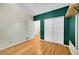 Bright bedroom featuring light hardwood floors, neutral paint and large closets at 12943 Lafayette St # F, Thornton, CO 80241