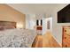 Cozy bedroom featuring light hardwood floors, a large bed, neutral walls, and natural light at 12943 Lafayette St # F, Thornton, CO 80241