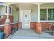 Close up of the front door and entrance with covered porch and brick accents at 12943 Lafayette St # F, Thornton, CO 80241