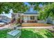 Charming townhome featuring a covered porch, brick accents, and well-manicured lawn at 12943 Lafayette St # F, Thornton, CO 80241