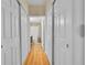 Hallway features wood floors and multiple storage closets at 12943 Lafayette St # F, Thornton, CO 80241