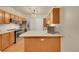 Updated kitchen with stainless steel appliances, wood cabinets, and ample countertop space at 12943 Lafayette St # F, Thornton, CO 80241