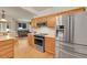 Well-lit kitchen featuring stainless steel appliances, modern fixtures, and a seamless connection to the inviting living area at 12943 Lafayette St # F, Thornton, CO 80241
