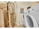 Functional laundry area equipped with a washer, dryer, and water heater providing convenience for daily chores at 12943 Lafayette St # F, Thornton, CO 80241