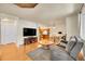 Open-concept living room with hardwood floors, modern decor, and ample natural light at 12943 Lafayette St # F, Thornton, CO 80241