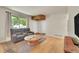 Inviting living area featuring hardwood floors, a stylish rug, and natural light at 12943 Lafayette St # F, Thornton, CO 80241