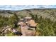 Aerial view of a multi-story home nestled in the mountains at 290 Skyhill Dr, Evergreen, CO 80439
