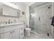 Elegant bathroom features double sinks, a marble countertop, and a tiled glass enclosed shower at 290 Skyhill Dr, Evergreen, CO 80439