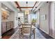 Elegant dining room featuring exposed beam ceilings, large windows, and mountain views at 290 Skyhill Dr, Evergreen, CO 80439