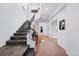 Inviting entryway featuring stone steps leading to an elegant staircase at 290 Skyhill Dr, Evergreen, CO 80439
