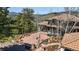 Beautiful home with a red tile roof, stone accents, and a spacious outdoor patio with mountain views at 290 Skyhill Dr, Evergreen, CO 80439