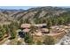 Luxury mountain home with tile roof, stone accents, and stunning views of the surrounding landscape at 290 Skyhill Dr, Evergreen, CO 80439