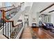 Grand foyer with wood staircase, iron railings, and views into the dining and living areas at 290 Skyhill Dr, Evergreen, CO 80439