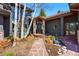 Charming front entrance with stone pathway, wooden door, and tasteful landscaping at 290 Skyhill Dr, Evergreen, CO 80439