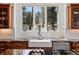 Gourmet kitchen with stainless steel appliances, farmhouse sink, and granite countertops at 290 Skyhill Dr, Evergreen, CO 80439
