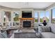 Inviting living room featuring a stone fireplace, large windows with mountain views, and comfortable seating at 290 Skyhill Dr, Evergreen, CO 80439