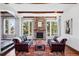 Cozy living room with stone fireplace, wood beams, and large windows with mountain views at 290 Skyhill Dr, Evergreen, CO 80439