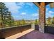Outdoor patio space with stone pillar and expansive views at 290 Skyhill Dr, Evergreen, CO 80439