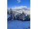 Beautiful winter landscape with snow-covered trees and mountains in the background on a sunny day at 290 Skyhill Dr, Evergreen, CO 80439
