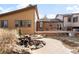 This backyard boasts a serene water feature, wooden deck, and lush landscaping, making it ideal for outdoor enjoyment at 7551 S Garland St, Littleton, CO 80128
