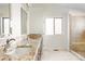 Bathroom features double vanity, granite counters, tiled shower and floors at 7551 S Garland St, Littleton, CO 80128