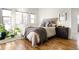 Comfortable bedroom with ample natural light, hardwood floors, and neutral decor at 7551 S Garland St, Littleton, CO 80128