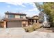 Charming two-story home featuring a brick and beige siding exterior and a well-maintained front yard with a two car garage at 7551 S Garland St, Littleton, CO 80128