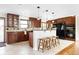 Well-appointed kitchen featuring dark wood cabinets, granite countertops, and modern appliances at 7551 S Garland St, Littleton, CO 80128