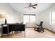 Home office with a large desk, a ceiling fan, and an exercise bench by the window at 7551 S Garland St, Littleton, CO 80128