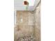 Elegant tiled shower featuring a glass enclosure, a showerhead, and a built-in seat at 7551 S Garland St, Littleton, CO 80128