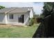 View of the backyard with a small concrete patio, grass, and a wooden fence at 18784 E Linvale Pl, Aurora, CO 80013