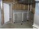 An unfinished basement room with exposed pipes and a door at 18784 E Linvale Pl, Aurora, CO 80013